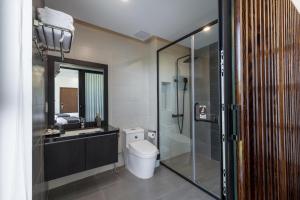 a bathroom with a toilet and a sink and a shower at Anchie Retreat Villa Hội An in An Bang