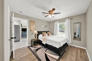 a bedroom with a bed and a ceiling fan at Elegant 4BD Near NRG stadium, Downtown in Houston