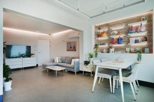 a living room with a table and a couch at Pension Haneul Tari in Jeju