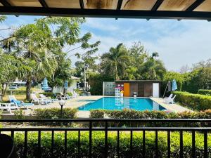 a view from a balcony of a swimming pool at Monmai Resort Huahin in Hua Hin