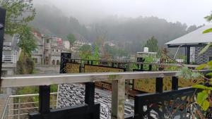 a balcony with a view of a city and a mountain at Ranim Family Lodge Abbottabad in Abbottābād +2 photos