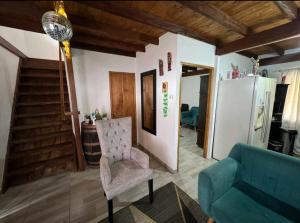 a living room with a couch and a chair at Finca la Esperanza in Guarne +17 photos