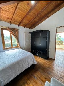 a bedroom with a large bed and a dresser at Finca la Esperanza in Guarne
