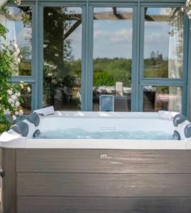 a bath tub in front of a window at Eryvazur in Vallauris