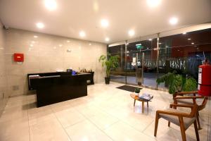 a lobby of a building with a desk and chairs at Perfect Balance Rest and Work Study Oceanfront in San Antonio +58 photos