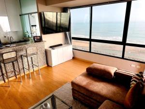 a living room with a couch and a view of the ocean at Perfect Balance Rest and Work Study Oceanfront in San Antonio