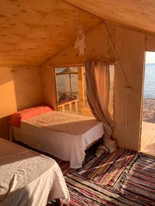 a bedroom with two beds in a room with a window at Leley Camp in Nuweiba +29 photos