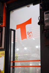 ein großes T-Schild an einem Schaufenster in einem Geschäft in der Unterkunft T Hotel Jalan Sultanah in Alor Setar