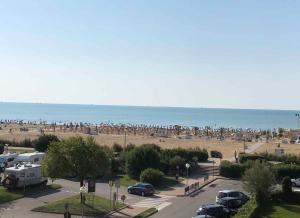 a view of a beach with a lot of people at Apartments in Bibione 54671 in Lo Stallone