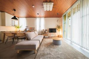 ein Wohnzimmer mit Sofa und Tisch in der Unterkunft Jomo Stay Takasaki 2 -the Garden- in Takasaki