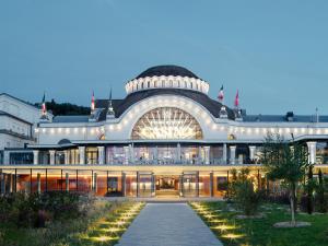 a large building with a pathway in front of it at Appartement cosy proche pistes ski avec garage - FR-1-498-112 in Thollon