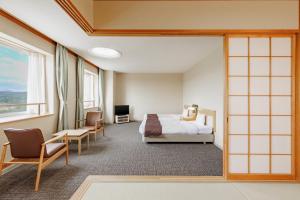 a hotel room with a bed and a window at KAMENOI HOTEL Ichinoseki in Ichinoseki +37 photos