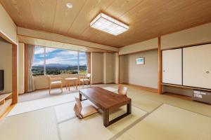 a living room with a table and a tv at KAMENOI HOTEL Ichinoseki in Ichinoseki