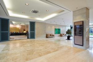 an empty lobby with a large room with a kitchen at Somerset Palace Seoul in Seoul