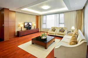 a living room with a couch and a coffee table at Somerset Palace Seoul in Seoul