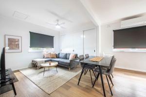 a living room with a couch and a table at Tamworth Loft - Cosy & Convenient, Ideal for Work in Dubbo