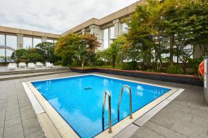 a swimming pool in front of a building at Somerset Palace Seoul in Seoul