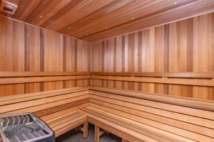 a large wooden sauna with a bench in it at Chic 3-Bed in Central with Pool, Sauna and Gym in Canberra