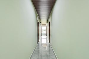 an empty hallway of a building with a ceiling at Hotel O Krishna Riverview Vijayawada Formerly Sikara in Krishna Canal
