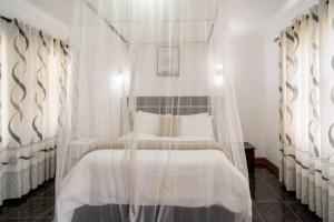 Ένα ή περισσότερα κρεβάτια σε δωμάτιο στο New Dawn Lodge