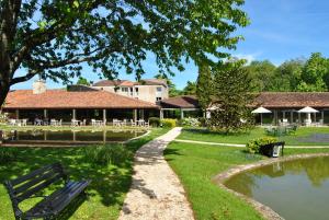 un parque con un banco junto a un estanque en Relais du Bois Saint Georges - Hôtel de Charme en Saintes