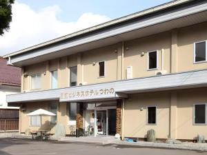 a building with a sign on the front of it at Business Hotel Tsuwano in Tsuwano