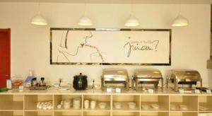 a sign on a wall above a counter with chairs at 7 Days Premium Dezhou Qingyun Nanhuan Building Materials Market in Dezhou