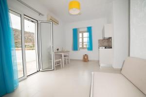 a living room with a large glass door and a table at Villa Stella Apartments by Estia in Stalís