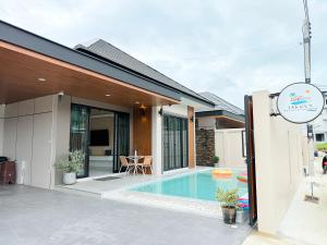 a house with a swimming pool in front of it at Jaegun Pool VIlla Aonang in Ao Nam Mao