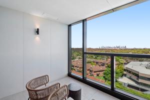 Zimmer mit 2 Stühlen und einem großen Fenster in der Unterkunft Skyview1-Bed, Infinity Pool, Cinema, Gym & BBQ in Melbourne + 6 Fotos