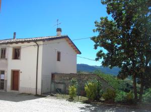 une maison blanche avec une clôture devant elle dans l'établissement Montagna & Relax, à Castel di Sangro