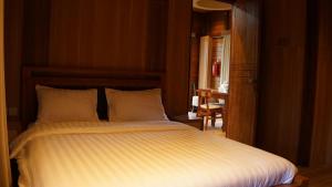 Ένα ή περισσότερα κρεβάτια σε δωμάτιο στο Eusabeia Villa And Hot Spring Water