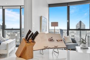a living room with a table with knives on it at Breathtaking City Views 1-Bed with Pool, BBQ & Gym in Brisbane +8 photos