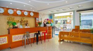 a woman sitting at a counter in a restaurant at Bluesea Hotel Quy Nhon in Quy Nhon