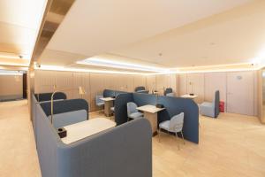a waiting room with blue booths and tables at Hanting Hotel Shanghai Xujiahui Jiaotong University Yishan Road in Shanghai