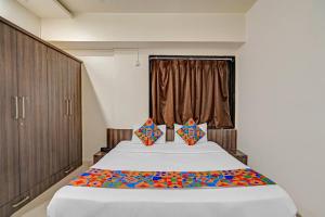 a bedroom with a large bed and a window at Via Shahi Villa in Pune