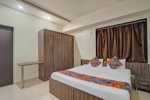 a bedroom with a large bed and a window at Via Shahi Villa in Pune