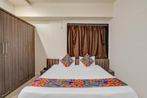 a bedroom with a large bed and a window at Via Shahi Villa in Pune