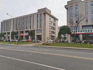 an empty street in front of a large building at Green Tree Inn Changzhou Liyang Zhongguancun Innovation Park in Liyang
