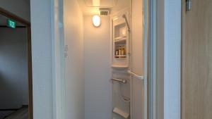 pasillo con nevera abierta en una habitación en Ippaku 一泊, en Izumisano