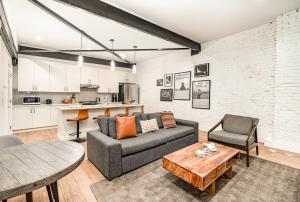 a living room with a couch and a table at The Saddlery-Playbill-4 Unit Combo-Walk 2 Broadway in Nashville
