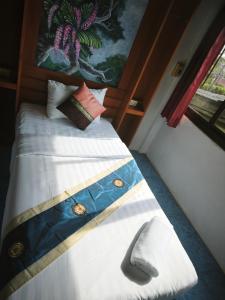 a bedroom with a bed with at StayStable Guest House in Ko Lanta Yai