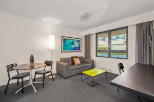a living room with a couch and a table at Contemporary 1-Bed First Floor Unit with Pool in Sydney