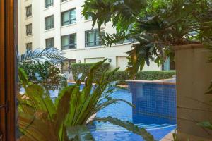 a swimming pool with plants and a building at Contemporary 1-Bed First Floor Unit with Pool in Sydney