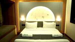 a bedroom with a large bed with an arch above it at The Lovedale Kodaikanal Stay & Hotel in Kodaikānāl