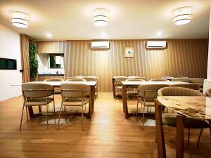 a conference room with tables and chairs in it at Pineapple Residence Pattaya in Pattaya