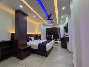a bedroom with a bed and a ceiling fan at G Mount inn in Munnar +69 photos