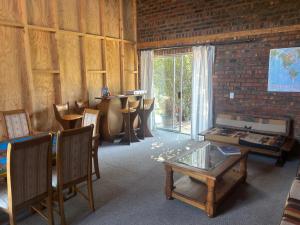 a room with a table and chairs and a window at Biba's Rooms in Smithfield