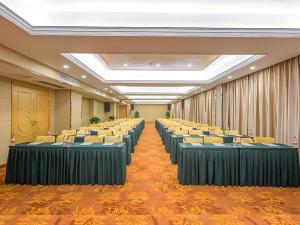 a conference room with rows of chairs and tables at Vienna Hotel Guangxi Fangcheng in Fangcheng