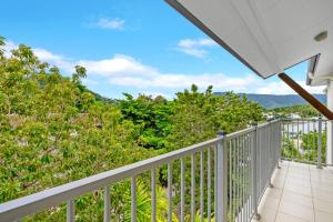 a balcony with a view of trees and mountains at Trinity Beach Retreat with Pool and Scenic Views in Trinity Beach